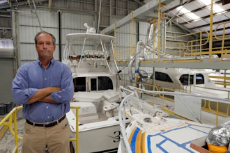 Peter Truslow, Chief Executive Officer for Bertram, a boat building company, poses near three of his custom made boats Friday, June 22, 2018, in Tampa, Fla.