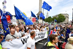 From centr carrying banner, British lawmaker Vince Cable, Pro-EU campaigners Gina Miller, Tony Robinson and lawmaker Caroline Lucas join crowds taking part in the People's Vote march for a second EU referendum, at Trafalgar Square in central London, Saturday June 23, 2018. Leading Brexit supporters are talking tough, and opponents are taking to the streets, on the second anniversary of Britain's vote to leave the European Union. Saturday marks two years since a June 23, 2016 referendum resulted in a decision to quit the 28-nation EU.