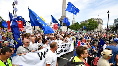 From centr carrying banner, British lawmaker Vince Cable, Pro-EU campaigners Gina Miller, Tony Robinson and lawmaker Caroline Lucas join crowds taking part in the People's Vote march for a second EU referendum, at Trafalgar Square in central London, Saturday June 23, 2018. Leading Brexit supporters are talking tough, and opponents are taking to the streets, on the second anniversary of Britain's vote to leave the European Union. Saturday marks two years since a June 23, 2016 referendum resulted in a decision to quit the 28-nation EU.