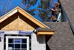 In this April 23, 2018, file photo, a worker installs vinyl siding on a new home in Auburn, N.H. On Monday, June 18, the National Association of Home Builders/Wells Fargo releases its June index of builder sentiment.