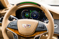 In this undated photo provided by General Motors a steering wheel light bar and cluster icons indicates an active status of Super Cruise in a Cadillac with the green light bar. General Motors is going to expand a hands-free driver-assist system to all Cadillac vehicles starting in 2020, with plans to roll it out to more brands in the future.
