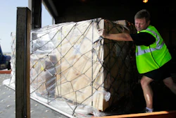 In this July 16, 2010, file photo, Mark Wilson pushes air cargo cleared for shipment to Santiago, Chile, at the American Airline cargo processing warehouse at Dallas-Fort Worth International Airport in Grapevine, Texas. U.S. authorities are requiring airlines to give them more notice about certain types of cargo that officials believe may pose a security risk. The new measure took effect Tuesday, June 12, 2018.