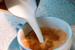 In this Sept. 22, 2017, file photo, a barista pours steamed milk into a cup of coffee at a cafe in Los Angeles. State health officials proposed a regulation change Friday, June 15, 2018, that would declare coffee doesn't present a significant cancer risk, countering a recent California state court ruling that had shaken up some coffee drinkers.