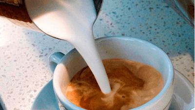 In this Sept. 22, 2017, file photo, a barista pours steamed milk into a cup of coffee at a cafe in Los Angeles. State health officials proposed a regulation change Friday, June 15, 2018, that would declare coffee doesn't present a significant cancer risk, countering a recent California state court ruling that had shaken up some coffee drinkers.