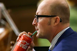 Assemblyman Matthew Harper, R-Huntington Beach, sips a Coke as Assembly members debate a ban on local soda taxes, Thursday, June 28, 2018, in Sacramento, Calif. Lawmakers passed a bill to ban local taxes on soda for the next 12 years and send it to the Gov. Jerry Brown. Harper did not cast on vote on the bill.