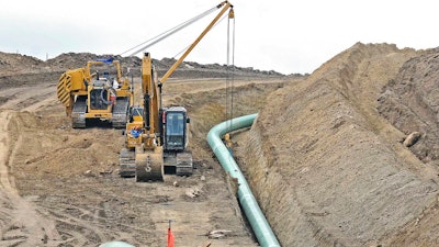 In this photo taken Oct. 5, 2016, heavy equipment is seen at a site where sections of the Dakota Access pipeline were being buried near the town of St. Anthony in Morton County, N.D. U.S. Army Corps of Engineers within the next two months expects to wrap up an environmental study of the oil pipeline after recently meeting with four American Indian tribes battling the pipeline in court. The tribe leading the lawsuit still feels it hasn't had a meaningful role in the study, and Standing Rock Sioux attorney Jan Hasselman said Monday, June 11, 2018, that 'the tribe is not giving up this fight' two years after the suit was filed and a year after oil began flowing.