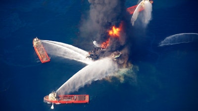 In this April 21, 2010, file photo, the Deepwater Horizon oil rig burns in the Gulf of Mexico following an explosion that killed 11 workers and caused the worst offshore oil spill in the nation's history. President Donald Trump is throwing out a policy devised by his predecessor for protecting U.S. oceans and the Great Lakes, replacing it with a new approach that emphasizes use of the waters to promote economic growth. President Barack Obama issued his policy in 2010 after the Deepwater Horizon oil spill in the Gulf of Mexico. Trump says it was too bureaucratic.