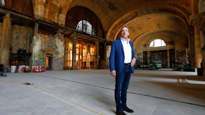 In this Thursday, June 14, 2018 photo, Bill Ford Jr., Ford Motor Company Executive Chairman and Chairman of the Board, poses in the Michigan Central Station in Detroit. Ford Motor Co. is embarking on a 4-year renovation of the 105-year-old depot and 17-story office tower just west of downtown. The massive project is expected to increase the automaker’s footprint in the city where the company was founded, provide space for electric and autonomous vehicle testing and research and spur investment in the surrounding neighborhood.
