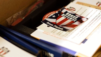 In this April 25, 2018, photo, literature is on display on the factory floor of Honor Defense, a gunmaker in Gainesville, Ga. In the wake of high-profile mass shootings, corporate America has been taking a stand against the firearms industry amid a lack of action by lawmakers on gun control. The moves are lauded by gun-safety advocates but criticized by the gun industry that views them as a backhanded way of undermining the Second Amendment. Gun industry leaders see the backlash as a real threat to their industry and are coming to the conclusion that they need additional protections in Congress to prevent financial retaliation from banks.