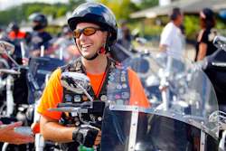 In this Aug. 31, 2013 file photo, Gov. Scott Walker laughs before riding in the Harley-Davidson 110th Anniversary Parade in Milwaukee, Wis. The ceremonial groundbreaking for a massive $10 billion Foxconn factory complex in Wisconsin was supposed to be evidence that the manufacturing revival fueled by President Donald Trump's 'America First' policy is well underway. But an announcement this week by Harley-Davidson that it is moving some production of motorcycles overseas to avoid tariffs is fueling unease among voters in Wisconsin _ a state Trump barely won and where fellow Republican Gov. Scott Walker is on the ballot.