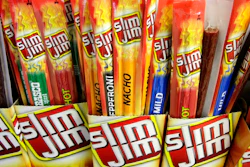 In this March 24, 2010, file photo, Slim Jim beef sticks stand on a shelf at a Shell gas station mini-mart in Bainbridge Twp., Ohio. Conagra, which has brands such as Slim Jim and Reddi-wip, is buying Pinnacle Foods Inc. in a cash-and-stock deal valued at about $10.9 billion that will help the food company expand in the frozen food and snacks categories.