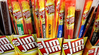 In this March 24, 2010, file photo, Slim Jim beef sticks stand on a shelf at a Shell gas station mini-mart in Bainbridge Twp., Ohio. Conagra, which has brands such as Slim Jim and Reddi-wip, is buying Pinnacle Foods Inc. in a cash-and-stock deal valued at about $10.9 billion that will help the food company expand in the frozen food and snacks categories.