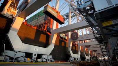 In this Jan. 30, 2018, file photo, a ship to shore crane loads two shipping containers together onto a vessel at the Georgia Ports Authority's Port of Savannah in Savannah, Ga. China's government renewed its threat Thursday, June 14, to scrap deals with Washington aimed at defusing a sprawling trade dispute as the White House prepared to release a list of Chinese goods targeted for tariff hikes.