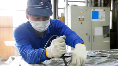 In this May 11, 2018 photo, a Sakae Casting employee works in the company shop in Hachioji, in the outskirts of Tokyo. Donald Trump’s trade relations with Tokyo are testy, but Idaho gave Takashi Suzuki a warm welcome. Suzuki’s Sakae Casting Co., which makes aluminum parts used for cooling batteries and semiconductors, is talking with the University of Idaho about possibly working together to develop technology to cool nuclear power plants. While Trump’s squabbles with Japan, Canada and Europe over steel tariffs grab headlines, companies such as Suzuki’s are forging their own deals with American states.