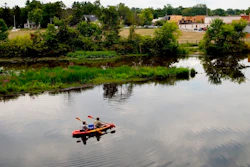 In this Aug. 14, 2017 file photo, a couple kayak on the Rogue River adjacent to where Wolverine World Wide's tannery once stood, in Rockford, Mich. The Michigan Department of Environmental Quality is investigating the connection between old waste drums in the area and an old Wolverine World Wide tannery waste dump nearby. Some private wells in the area have tested positive for elevated levels of per- and polyfluoroalkyl substances called PFAS, also called perfluorinated chemicals, or PFCs. A government report shows that a family of industrial chemicals turning up in public water supplies around the country threatens human health at concentrations seven to 10 times lower than previously realized. The chemicals are called perfluoroalkyl and polyfluoroalkyl.