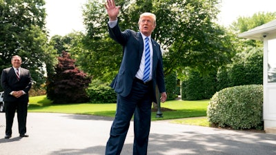 President Donald Trump, center, accompanied by Secretary of State Mike Pompeo, left, speaks to members of the media on the South Lawn outside the Oval Office in Washington, Friday, June 1, 2018, after meeting with former North Korean military intelligence chief Kim Yong Chol. After the meeting Trump announced that the Summit with North Korea will go forward.