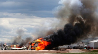 The Ultramax Ammunition company is engulfed in flames Tuesday, May 8, 2018, north of Interstate 90 and just east of Rapid City, S.D. Fire crews were worried about exploding ammunition and evacuated the area around the blaze.