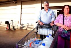 In this Tuesday, May 29, 2018 photo, Mark Schonbrun, 72, and Linda Schonbrun, 66, of West Salem, purchase water following a tap water contamination warning for people in Salem at WinCo Foods in Salem, Ore.