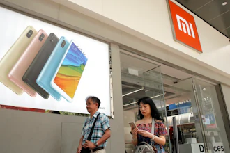 In this Wednesday, June 20, 2018, photo, people walk past a Xiaomi store in Hong Kong. Xiaomi, a Chinese startup that helped to pioneer the trend toward ultra-low-priced smartphones, is preparing for what would be the biggest initial public offering since e-commerce giant Alibaba's in 2014. The 8-year-old is a star among the Chinese unicorns, a term that refers to startup companies that are valued at more than $1 billion. It has a dedicated Chinese fan base and its media-savvy leader is an Asian celebrity. But it is untested outside the region.