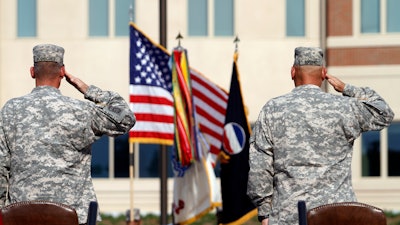 In this Sept. 12, 2011 file photo, generals salute during an installation ceremony at the U.S Army Forces Command at Fort Bragg, N.C., one the Army's three major command headquarters. The Army is scouting large cities in 2018 to find a home for a fourth command headquarters, one that would be near experts in technology and innovation who can help focus on the Army's future. The site is expected to be announced by the end of June 2018.