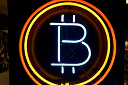 In this Feb. 7, 2018 file photo, a neon sign hanging in the window of Healthy Harvest Indoor Gardening in Hillsboro, Ore., shows that the business accepts bitcoin as payment. A raft of recent cyber-security firms and governments now cite the rising trend of ‘crypto-jacking’ _ in which devices are infected with invisible malicious cryptocurrency mining software that uses the computing power of victims’ devices to mine virtual currency _ as the main cyber security threat to businesses and consumers worldwide.