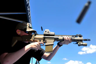 In this June 28, 2014 file photo, a bullet casing flies from the rifle as Derrick Campbell fires downrange at targets during the second annual Freedom Shoot at Pawnee Sportsmen Center near Briggsdale, Colo. The California Supreme Court will decide whether state laws can be challenged in court on the grounds that complying with them is impossible in a lawsuit over a California law that requires new models of semi-automatic handguns to stamp identifying information on bullet casings.