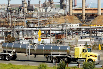 This March 9, 2010, file photo shows a tanker truck passing the Chevron oil refinery in Richmond, Calif. A U.S. judge who held a hearing about climate change that received widespread attention has thrown out the underlying lawsuits that sought to hold big oil companies liable for the role of fossil fuels in the Earth's warming environment. Judge William Alsup in San Francisco said Monday, June 25, 2018, that Congress and the president, not a federal judge, were best suited to address fossil fuels' contribution to global warming.