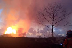 In this photo provided by the U.S. Geological Survey, crews make visual observations of lava activity at fissure 8, Thursday, May 31, 2018 near Pahoa, Hawaii. Fountain heights Thursday morning continued to reach 230 to 260 feet (70 to 80 meters) above ground level. The fountaining feeds a lava flow that is moving to the northeast along Highway 132 into the area of Noni Farms road.