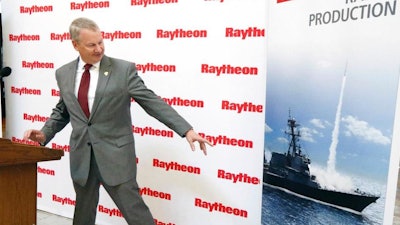 Wes Kramer, president of Raytheon's Integrated Defense Systems business, points to the radar housing on a U.S. Navy war ship poster, Thursday, May 31, 2018, and says his company plans to invest $100 million in its Forest, Miss., plant, to test and make military radars, during a news conference at the Capitol in Jackson, Miss. In addition, Raytheon will construct a new 50,000-square-foot facility to serve as the hub for testing, integration and production of s-band radars, including the U.S. Navy's next -generation SPY-6, Air and Missile Defense Radar program.