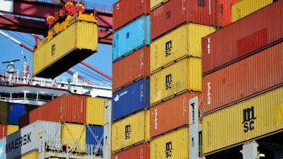 In this April 8, 2018 file photo, a container is loaded onto a cargo ship at a port in Qingdao in east China's Shandong province. China has accused the United States on Thursday, June 21, 2018, of using pressure tactics and blackmail in threatening to impose tariffs on hundreds of billions of dollars of Chinese imports.