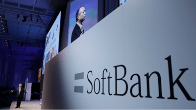 In this July 20, 2017, file photo, SoftBank Group Corp. Chief Executive Officer Masayoshi Son, left, speaks during a SoftBank World presentation at a hotel in Tokyo. SoftBank will spend $2.25 billion for a nearly a 20 percent stake in General Motors’ autonomous vehicle unit. GM said Thursday, May 31, 2018, that it will also sink another $1.1 billion into Cruise Automation. The capital infusion is designed to speed large-scale deployment of self-driving robotaxis next year.