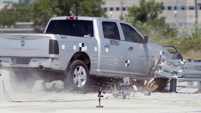 A Dodge pickup traveling at more than 60 mph decelerates as a median barrier absorbs the energy during a crash test at UNL’s Midwest Roadside Safety Facility in Lincoln, Neb. A University of Nebraska-Lincoln engineering team is testing an improved highway safety device to ensure it meets new safety standards the university experts helped write.