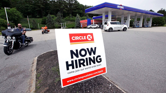 In this June 20, 2018, photo, a 'Now Hiring' sign is posted outside a gas station in Raymond, N.H. On Tuesday, July 10, the Labor Department reports on job openings and labor turnover for May.
