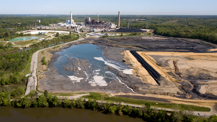 In this May 1, 2018 file photo, the Richmond city skyline can be seen on the horizon behind the coal ash ponds along the James River near Dominion Energy's Chesterfield Power Station in Chester, Va. The Trump administration is easing rules for handling toxic coal ash from more than 400 coal-fired power plants across the U.S. after utilities objected to regulations adopted under former President Barack Obama. Environmental Protection Agency acting Administrator Andrew Wheeler said Wednesday, July 18, 2018, the changes will save utilities roughly $30 million annually.