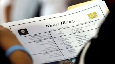 In this Thursday, June 21, 2018 photo, a job applicant looks at job listings for the Riverside Hotel at a job fair hosted by Job News South Florida, in Sunrise, Fla. The Labor Department said Friday, July 6, that the unemployment rate rose to 4.0 percent from 3.8 percent as more people began looking for work and not all of them found it.