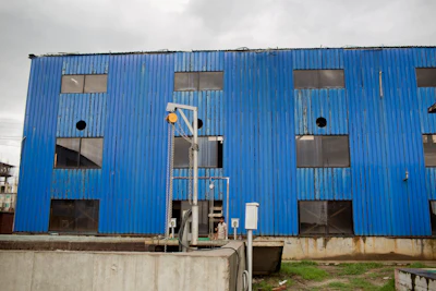 In this Thursday, June 28, 2018, photo, a Bangladeshi worker stands next to an Industrial water purifying machine room at Tannery Industrial Area on the banks of the Daleshwari River in Savar, Bangladesh. Bangladesh tanneries prepping leather for shoes, belts, wallets and purses are dumping toxic chemicals into the Daleshwari river at a new industrial complex more than a year after the government shut them down for poisoning another river and using child labor.
