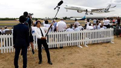 An Airbus A350-1000 lands after a flying display at the Farnborough Airshow in Farnborough, England, Monday, July 16, 2018.