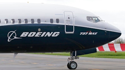 In this April 13, 2017, file photo, a pilot waves from the flight deck of a Boeing 737 MAX 9 as it rolls out for the airplane's first flight, in Renton, Wash. Boeing and the Brazilian jet maker Embraer will attempt to form a joint venture that would push the U.S. aerospace giant more aggressively into the regional aircraft market.