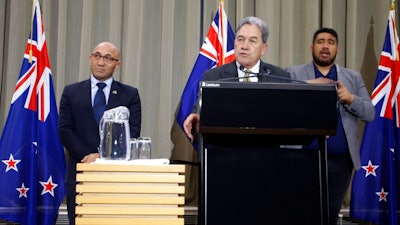 New Zealand's Acting Prime Minister Winston Peters, center, and Defense Minister Ron Mark, left, talk to reporters in Wellington, New Zealand Monday, July 9, 2018. They announced that New Zealand has agreed to buy four Boeing maritime patrol planes from the U.S.
