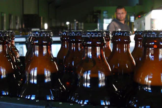 In this June 5, 2018, photo, bottles of freshly bottled beer stand in the Darling Brewery in Darling, South Africa. The South African brewery appears to be the first in Africa to go carbon-neutral as more businesses across the continent adjust to climate change, and as consumers become more careful about the products they buy.
