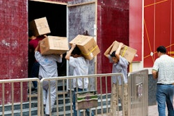 Workers carry boxes of LED lights into a renovation site in Beijing, China, Tuesday, July 3, 2018. Barring a last-minute breakthrough, the Trump administration on Friday will start imposing tariffs on $34 billion in Chinese imports. And China will promptly strike back with tariffs on an equal amount of U.S. exports.