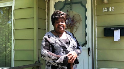 In this June 6, 2018 photo, Alice Holland stands outside the front door of her home in Detroit's Brightmoor neighborhood. Holland likes how things are improving in Detroit five years after the city filed the largest municipal bankruptcy in U.S. history, but says more improvements can be made in city neighborhoods. Holland complains that trash-clogged drains cause some streets in Brightmoor to flood during heavy rains.