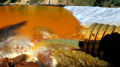 In this Aug. 14, 2015 file photo, water flows through a series of sediment retention ponds built to reduce heavy metal and chemical contaminants from the Gold King Mine wastewater accident outside Silverton, Colo. The U.S. Environmental Protection Agency is asking a federal court in New Mexico to toss out a lawsuit over a mine waste spill in Colorado that polluted rivers in three states.