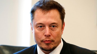 In this Dec. 14, 2016, file photo, Tesla CEO Elon Musk listens as President-elect Donald Trump speaks during a meeting with technology industry leaders at Trump Tower in New York. Musk has apologized for calling a British diver involved in the Thailand cave rescue a pedophile. In a series of tweets late Tuesday, the Tesla CEO said he had 'spoken in anger' on Sunday after diver Vern Unsworth accused Musk of orchestrating a 'PR stunt' by sending a small submarine to help divers rescue the soccer players and their coach from a cave.