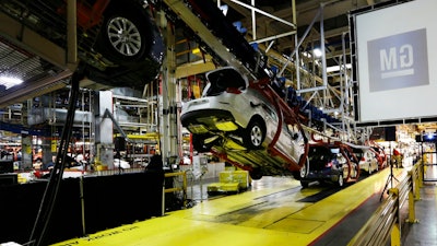 In this Monday, Jan. 28, 2013, file photo, cars move along an assembly line at the General Motors Fairfax plant in Kansas City, Kan. Analysts say that with too many factories making slow-selling cars, General Motors can’t afford to keep them all operating without making some tough decisions.