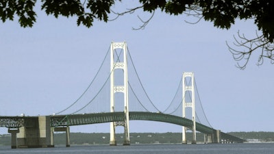 The Mackinac Bridge spans the Straits of Mackinac. A draft of a report commissioned by the state of Michigan outlining a worst-case scenario oil spill from a pipeline in the Straits of Mackinac calculates clean-up, restoration and liability costs at almost $2 billion.