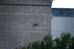 In this photo released by Greenpeace, a drone resembling the character Superman crashes into a wall of the nuclear power plant of Le Bugey, central, France, Tuesday, July 3, 2018. The environmental activist group says the drone was harmless but the action showed the lack of security in nuclear installations in France, which is heavily dependent on atomic power.