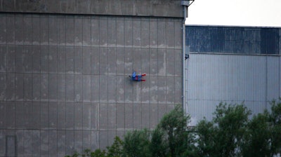 In this photo released by Greenpeace, a drone resembling the character Superman crashes into a wall of the nuclear power plant of Le Bugey, central, France, Tuesday, July 3, 2018. The environmental activist group says the drone was harmless but the action showed the lack of security in nuclear installations in France, which is heavily dependent on atomic power.