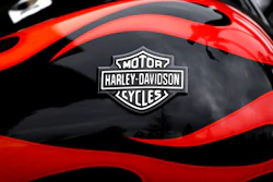 This April 27, 2017, file photo shows the Harley-Davidson name on the gas tank of a bike in Glenview, Ill. The iconic American motorcycle company, facing dwindling sales in its home market, said Monday, July 30, 2018, that it would be rolling out some new products, and stores, to broaden its audience and hopefully, invigorate sales.