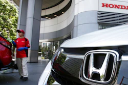 An employee of Honda Motor Co. cleans a Honda car displayed at its headquarters in Tokyo, Tuesday, July 31, 2018. Honda profits jumped 17.8 percent in the latest quarter, driven by strong auto sales in North America and motorcycle sales in Asia, the company said Tuesday.